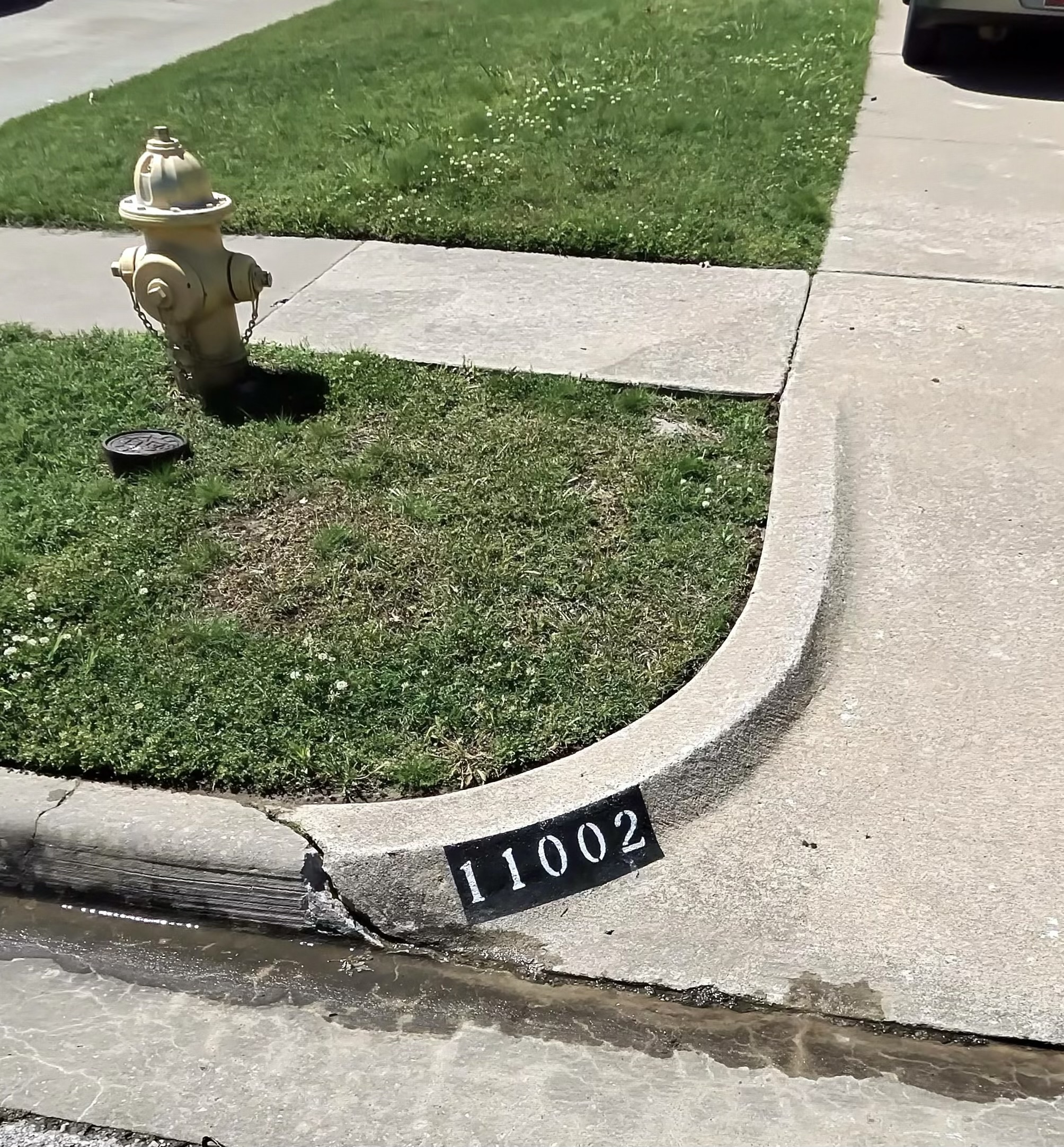 Painted curb number 11002 in Owasso